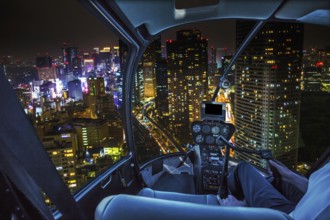 Helicopter flying over Tokyo cityscape and Shiodome skyscrapers and business offices view from