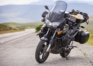 On tour with a black Honda Varadero, against a natural backdrop