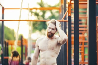 Subject sport street workout Handsome young caucasian man with a bare-chested muscular with long