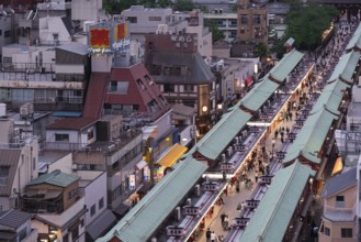 Tourists walk through the Nakamise-dori shopping street of Senso-ji in Asakusa. Senso-ji is the