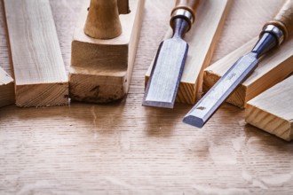 Chisels and plane on planks on wooden board
