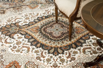 Antique chair and table on the decorated oriental carpet