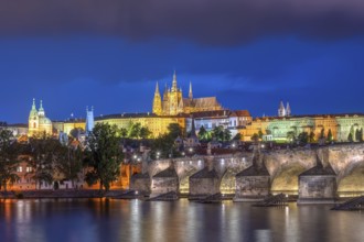 The imposing St Vitus Cathedral and Charles Bridge in Prague by night