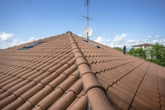 Red roof of the building against the blue sky. Copyspace for text, promotion or advertisement