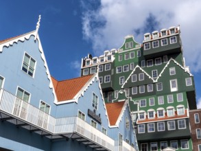 Detail of modern green hotel building as with many stacked small traditional buildings of Inntel