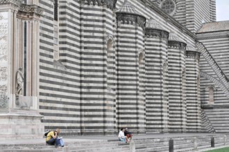 The Cathedral Basilica of Santa Maria Assunta, Orvieto, Terni, Umbria, Italy, People sitting in