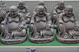 Decorative material, Sitting grey Buddha figures in a DIY store, Allgäu, Swabia, Bavaria, Germany