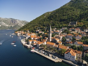 Drone view of the Perast coast with ancient houses and a tower. Montenegro.