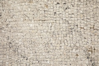Mosaic floor as a texture of white little stones with dirt and crumbs