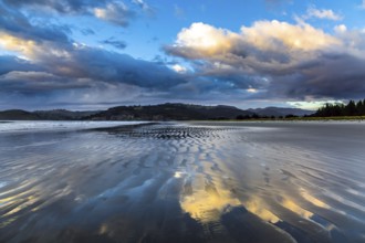 Low tide. Strips of sand and water left by the ocean tide. Sunrise over the ocean. New Zealand,