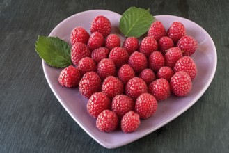 Raspberries in a heart-shaped bowl