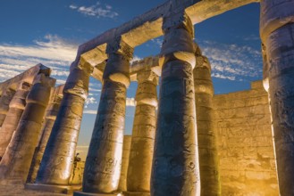 Illuminated columns in Luxor Temple at sunset, Egypt