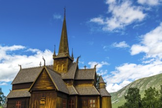 The famouse historic wooden church in Lom in Norway with blue sky summertime