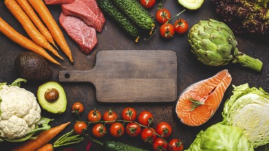 Assorted food raw products: vegetables, beef meat, fish salmon and empty wooden cutting board in