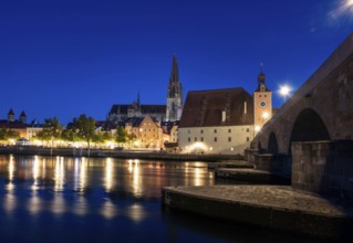 Regensburg cityscape during blue hour with light reflections in the river Danube