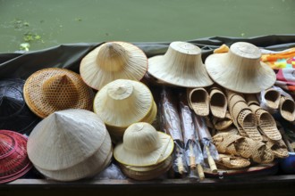 Boat with hats on floating market Damnoen Saduak in Bangkok, Thailand