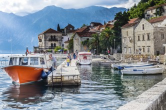 PERAST, MONTENEGRO, JUNE 18: View on embankment and boats in old town on June 18, 2014 in Perast,