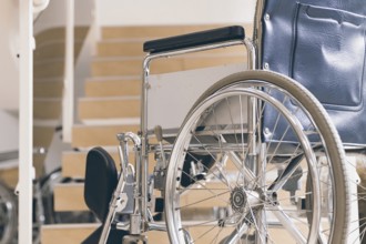 Empty wheelchair and stairs. Disabled accessibility reality