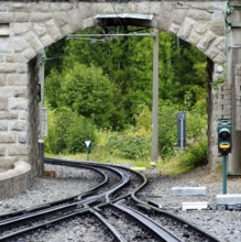 Track section of a rack railway with a switch and signalling system