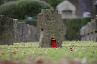 Gravestones and grave light at a military cemetery from the Second World War in Germany