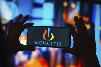 In this photo illustration, the Novartis logo is displayed on a smartphone screen