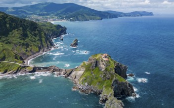 Drone shot, Aerial view of a rugged coastline with cliffs and a small island surrounded by blue