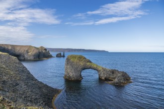 Rocky coast with Gatastakkur rock gate, Rauðanes peninsula, Norðurland eystra, Iceland