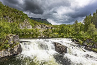 Magnificent seething waterfall - the threshold on the river Bioreio. The interesting trip to the