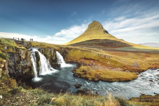 Landscape view of Kirkjufellsfoss In the daytime, blue sky and beautiful clouds. The waterfall is