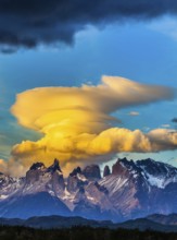 The black-and-steel color of the cliffs of Los Cuernos. Magnificent clouds in the rays of the