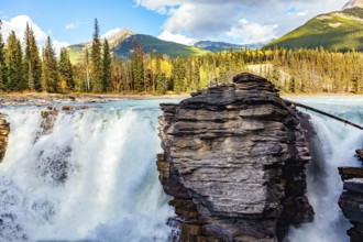 Magnificent rock divides thundering Athabasca Falls. Athabasca Falls is the most powerful waterfall