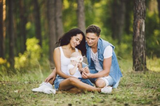 The theme family outdoor recreation in forest park area. Young beautiful stylish caucasian family