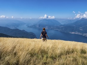 Woman walking in a prairie on Lake Como alps