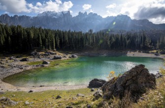 Lake Carezza or Karersee lake with deep blue colored water and the dolomite mountain range Trentino
