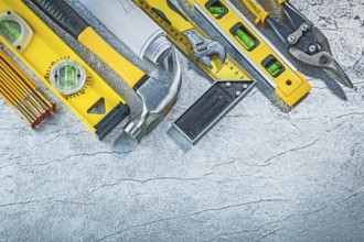 Assortment of construction tools on abstract metallic background building concept