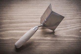 Hand angle former with wooden handle on wood board