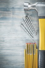 Claw hammer nails wooden meter on wood board construction concept