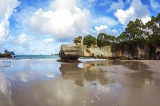 Cathedral Cave on the North Island of New Zealand. Coromandel Peninsula. Bizarre clouds and coastal