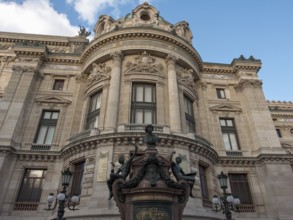 Fascinating front view of a magnificent opera house with richly decorated façade elements and