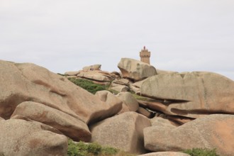 Granite boulder and lighthouse in Brittany, France