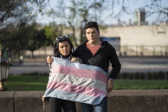 LGBT couple holding transgender flag