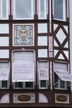 An old listed residential and commercial building of a former pharmacy with the coat of arms of the