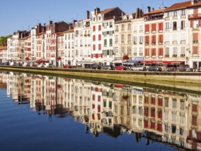 Reflections of the buildings of Quai Amiral Dubourdieu in the Nive River, Bayonne, France