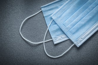 Surgical masks on grey background