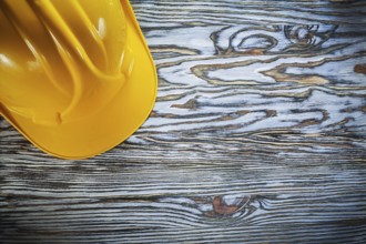 Safety hard hat on vintage wooden board