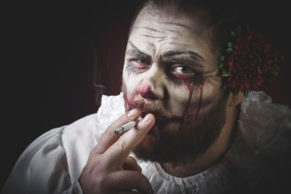 Portrait of a Scary Evil Clown. Studio shot with horrible face art