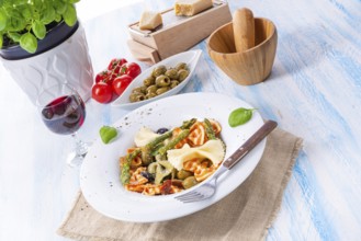 Colourful farfalle with green asparagus olives and parma ham