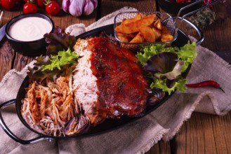 Delicious pulled pork with jacket potato quarters