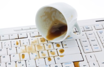 Coffee cup spilled on a computer keyboard. Damage for insurance company. Austria