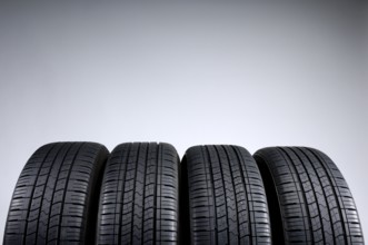 Set of all-season tires isolated on gray background